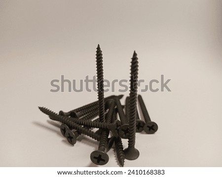 Black screws made from iron on a white background