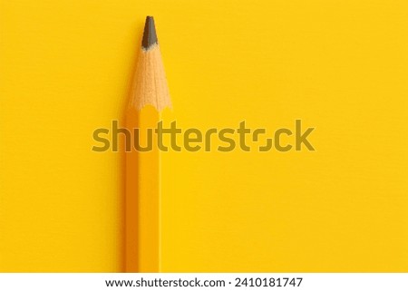 Minimalist Yellow Pencil on a Vibrant Yellow Background