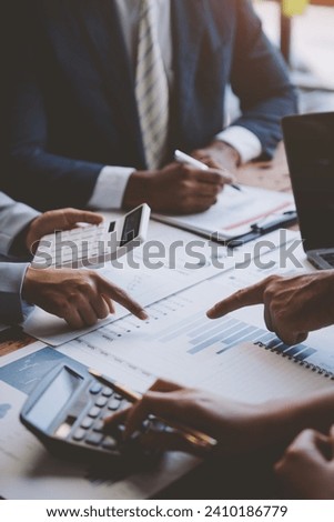 Analyzing results, an accountant, businessman or financial expert analyzes results. Calculates results from graphs, business reports and financial charts. Company stock market. Royalty-Free Stock Photo #2410186779