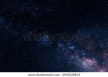 The purple and blue hues in a Milky Way galaxy photo taken in Sedona, Arizona, result from long-exposure photography capturing the vivid colors of celestial objects and the night sky.  Royalty-Free Stock Photo #2410220813
