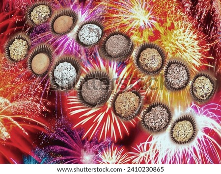    Lots of handmade chocolates with nut sprinkles, against the backdrop of multi-colored fireworks. For advertising sweets, for postcards, posters.                             Royalty-Free Stock Photo #2410230865