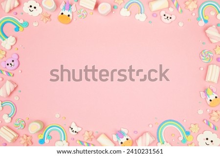 Cute pastel pink kawaii background with frame made of cute air plasticine handmade cartoon animals, unicorns, stars, rainbows. Flat lay, top view, copy space. Beautiful childlike design template Royalty-Free Stock Photo #2410231561