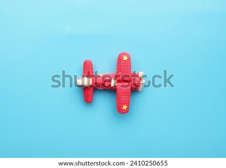 A flatlay picture of classic aircraft on blue background. Travel and adventure concept.