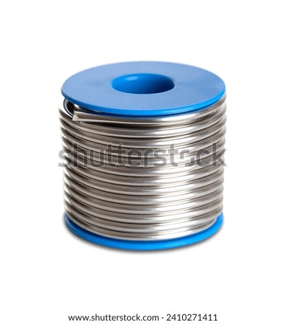 Spool of soft solder wire, with a diameter of 3 millimeters. Fittingslot, fusible metal alloy of tin and copper, used to create a permanent bond between metal workpieces. Close-up, front view. Photo. Royalty-Free Stock Photo #2410271411