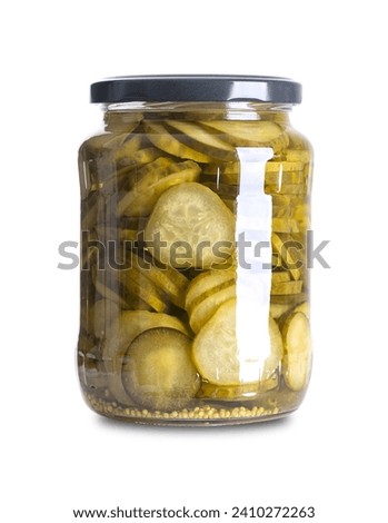 Burger gherkins, pickled cucumber slices, in a glass jar. Crisp round cucumber slices, pasteurized and preserved in a brine of vinegar, salt, mustard seeds and dill. Ingredient between bun halves. Royalty-Free Stock Photo #2410272263