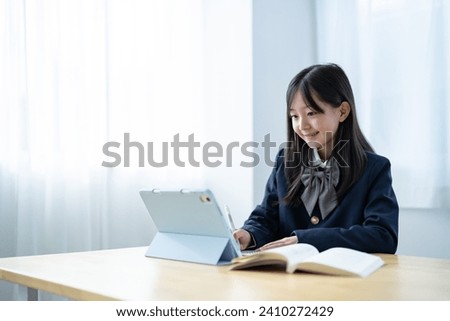 Japanese girl studying in her room Royalty-Free Stock Photo #2410272429