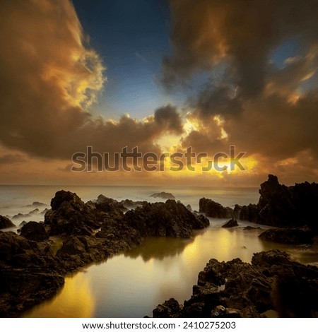 Tropical rocky beach at sunrise ( long exposure photography), Soft effect due to long exposure shot.