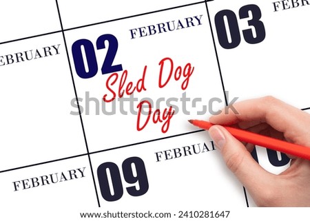 February 2. Hand writing text Sled Dog Day on calendar date. Save the date. Holiday.  Day of the year concept. Royalty-Free Stock Photo #2410281647