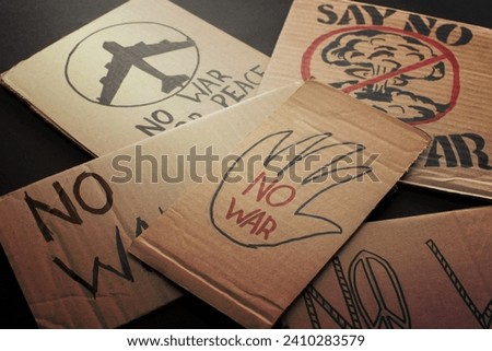 cardboard placards war lettering black Royalty-Free Stock Photo #2410283579