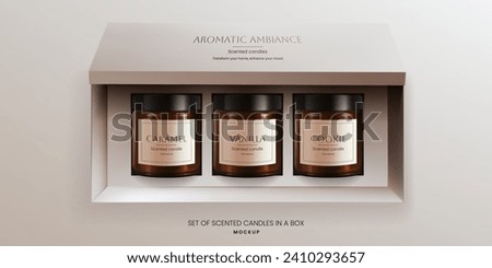 A realistic 3D vector mockup of scented vanilla candles in brown glass jars in a open packaging box, front view. The design offers an ideal template for advertising aromatherapy products. Not AI. Royalty-Free Stock Photo #2410293657