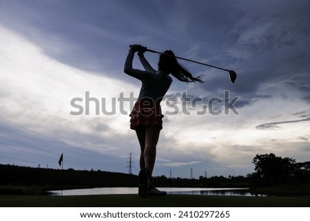 silhouette of professional young asian woman golfer practice in golf course, 
