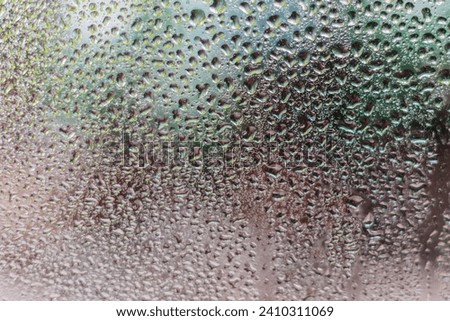 Water vapor, water drops, raindrops against a dark background serve as the background.