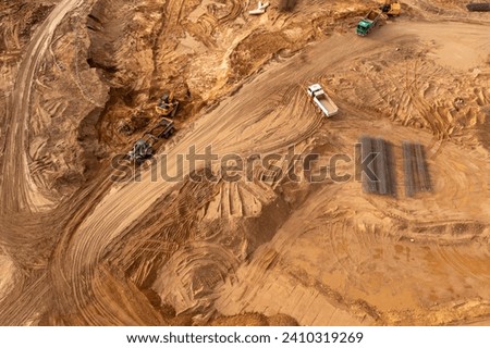 Drone photography of construction site and construction machinery delivering during autumn sunny day
