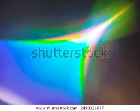 Bandung, Jan 09, 2024 : Disfocus of colorful abstract pattern flash light rays on white cardboard surface using triangle prism at home.