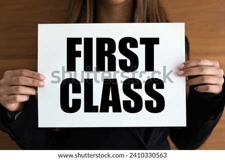 First Class. Woman with white page, black letters. Premium, VIP, business lounge, noble. Royalty-Free Stock Photo #2410330563