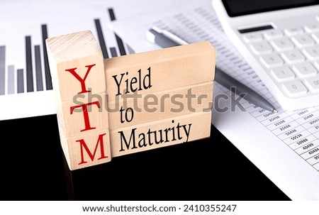 Word YTM Yield To Maturity made with wood building blocks, business