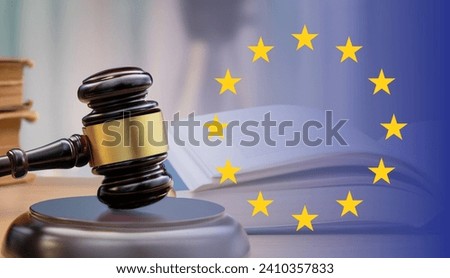 European Union flag with wooden gavel in close-up. Justice, law and legal concept. Royalty-Free Stock Photo #2410357833