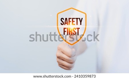 Employee touch the safety banner symbol on hand. Concept of workplace hazards, Hazard surveillance, Safety first symbol, Working zero accident, Worker safety awareness at work.
