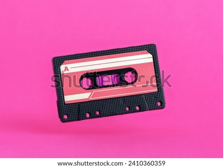 Retro vintage tape cassette on pink background. Minimal art poster.