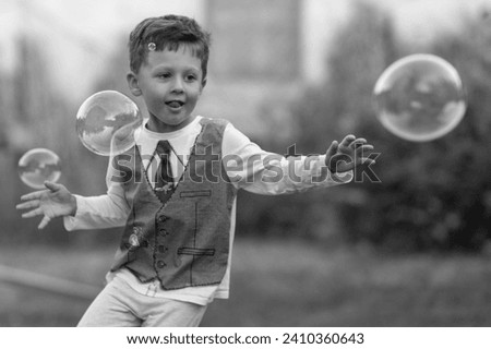 Beautiful baby boy with child soap bubbles posing photographer for cool photo, cadre consisting of baby boy in child soap bubbles and caucasian expression face, healthy baby boy on child soap bubbles