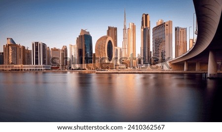 Dubai, UAE, January 12 2023: Dubai Downtown skyline landscape with reflections in Dubai Creek at sunrise, from Dubai Creek Harbour promenade. UAE Royalty-Free Stock Photo #2410362567