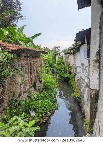 River where there are buildings and slum settlements