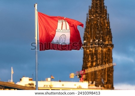 Hamburg flag in front of the tower of the Nikolai Church