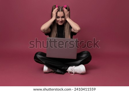Photo of pretty young woman with laptop holding her head wear black t-shirt sitting on ruby color background