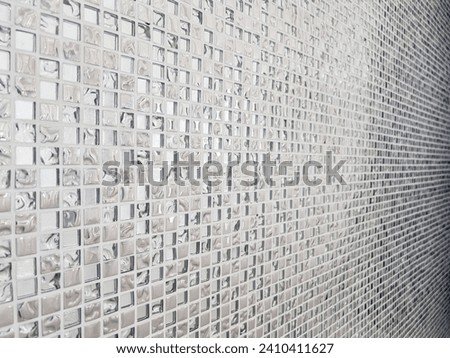 Small silver tiles Small silver tiles are arranged to fit the background. Silver glass tile mosaic background. silver mosaic texture background