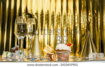 Background date of birth with number 93. Scenery festive glasses of champagne, anniversary in golden color. Copy space. Happy birthday postcard. Royalty-Free Stock Photo #2410419901
