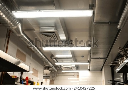 Restaurant kitchen ceiling. Ventilation system in cafe. Ensuring air circulation for food establishments. Galvanized ventilation pipes in confectionery shop. Ventilation equipment for restaurants Royalty-Free Stock Photo #2410427225