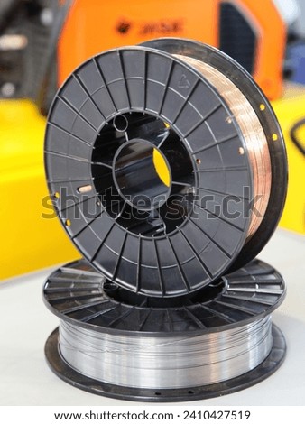 Two Welding wire coils closeup. MIG MAG automatic welding equipment Royalty-Free Stock Photo #2410427519