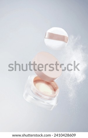 Pink makeup holding, fixing, dispersing powder, honey powder floating, powder splashing Royalty-Free Stock Photo #2410428609