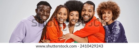 cheerful african american people in colorful casual wear having fun together on grey, banner