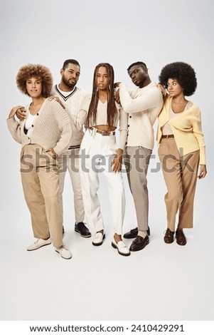 african american men and woman in casual attire standing on grey background, Juneteenth concept