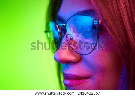 Focused developer, woman wears glasses working on computer looking at programming code which reflecting in glasses. Concept of trading, financial growth, technology, cyber security. Ad
