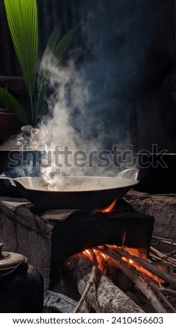 This photo presents a beautiful picture of a traditional kitchen that still uses wood to light the fire.