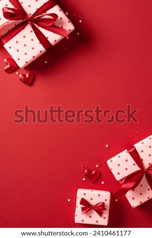 Valentines day poster template. Flat lay Valentine gifts and hearts on red background. View from above.