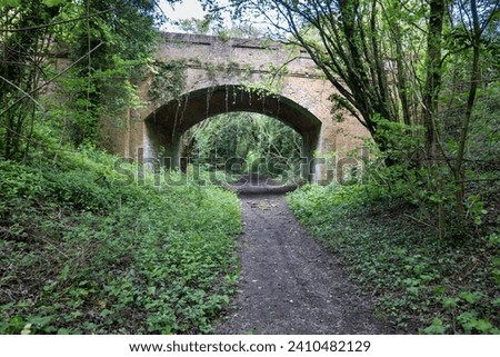 Old Burghclere, Hampshire, England - July 10th 2023: Bridge on the disused Didcot to Southampton railway line looking north Royalty-Free Stock Photo #2410482129
