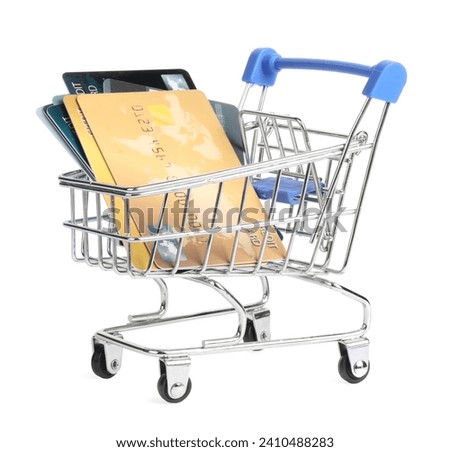 Small metal shopping cart with credit cards isolated on white