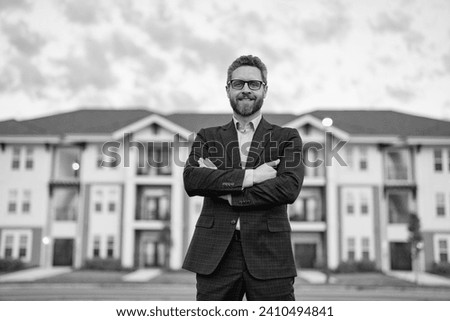 photo of happy man realtor in the suit outdoor at the house