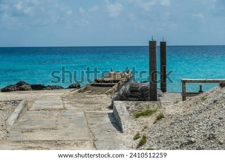 A photo looking out at the Pacific Ocean over an old pier in French Polynesia