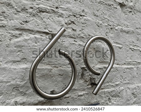 Close up of an house door number 69