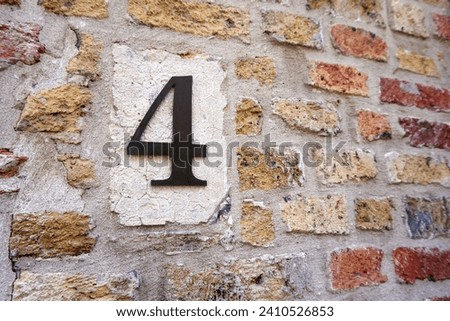Close up of an house door number 4