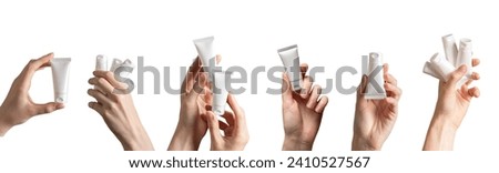 Hand holding cream tubes mockups, beauty product packages, cosmetic packs isolated on white, set Royalty-Free Stock Photo #2410527567
