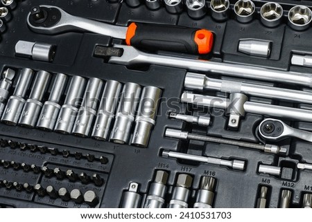 Tool box, tool kit closeup with set of hex, torx and screwdriver bits and ratchet wrench sockets Royalty-Free Stock Photo #2410531703