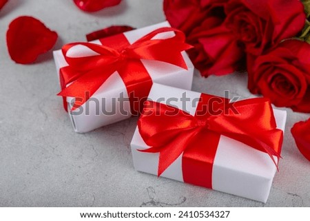 Valentine's Day concept.Valentine's Day background. Gifts, candles, confetti, envelope, candies, glasses, wine and a bouquet of roses on a colored background. Flatley.Valentine's day celebration