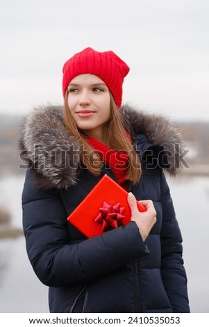 A young woman is holding a red box in her hands. Valentine's day concept