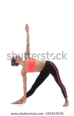 Sporty yoga girl on white background in utthita trikonasana (extended triangle pose)