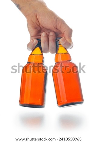 Bottles of beer in hand  isolated on the white background.
